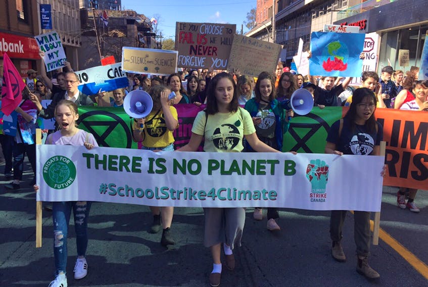Students lead the way as protesters participating in the massive global climate crisis strike make their way through downtown Halifax on Friday, Sept. 27, 2019.