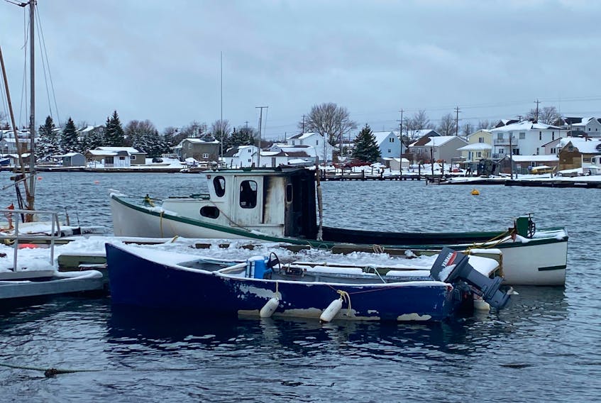 A fishing boat damaged in an overnight fire sits at a dock in Eastern Passage on Friday morning, Dec. 18, 2020.