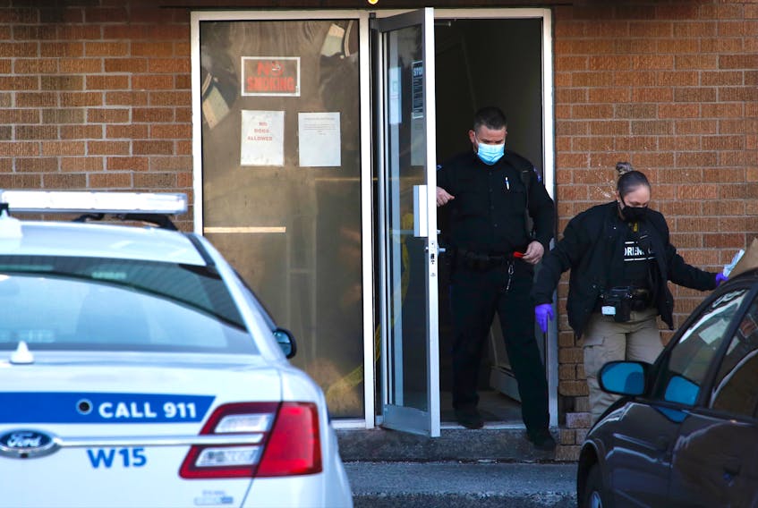 Forensics officers with Halifax Regional Police leave an apartment building at 201 Rutledge St. in Bedford on Tuesday morning, March 2, 2021. A fire there late the night before is being investigated as an arson.