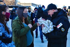 Sailor First Class Justin Steele meets son Tommy for first time after HMCS Toronto returned Wednesday to Halifax. Pictured here with his wife, Ashley, and daughter, Theresa.