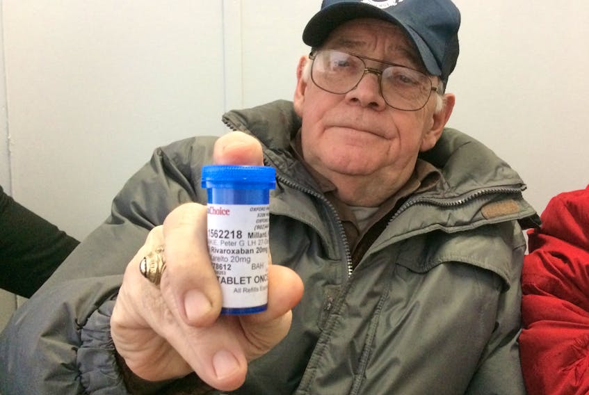 Rubin Millard holds up a bottle of Xarelto that he has to pay for because the provincial pharmacare program won’t pay for.