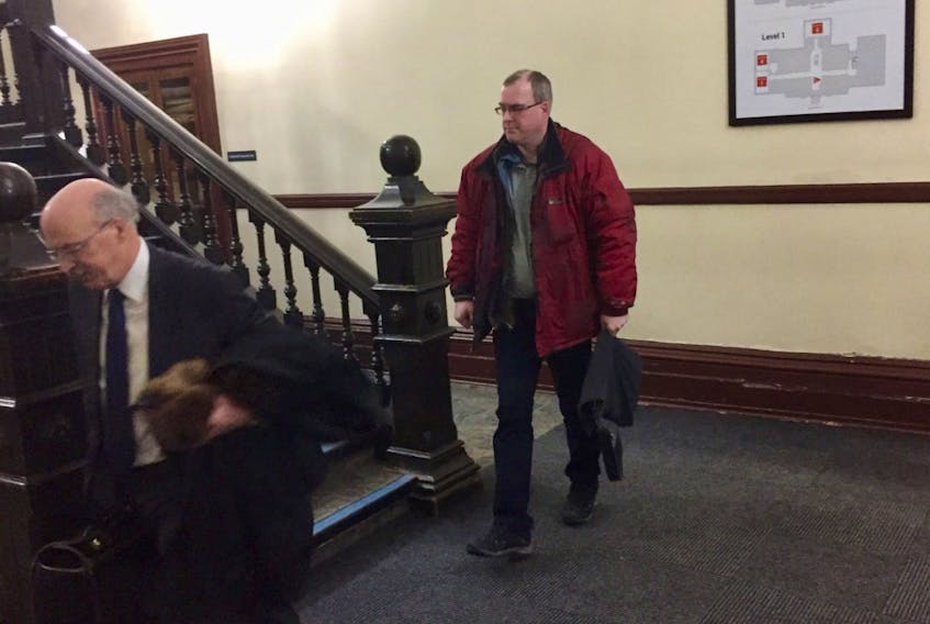 Philip Travers Milo, right, leaves Halifax provincial court with lawyer Don Murray following a February 2020 appearance on charges of possessing and distributing child pornography.