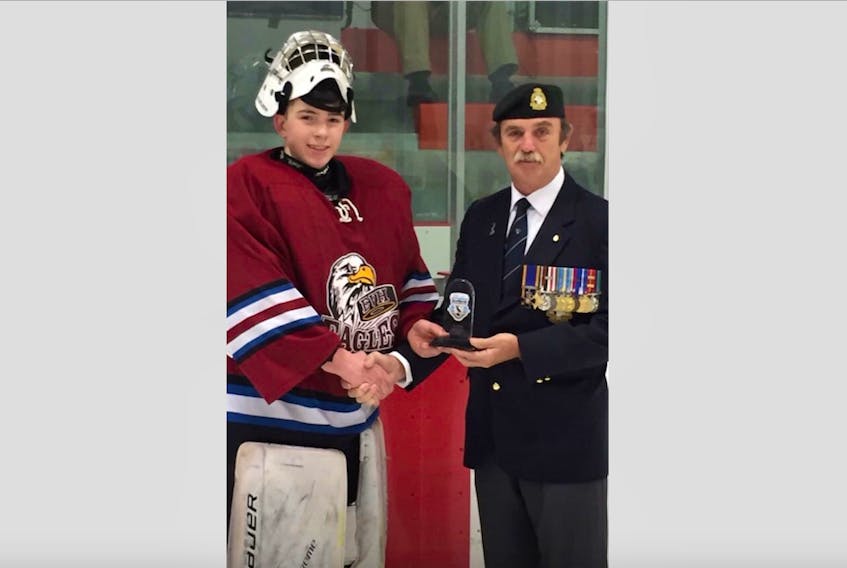 Grand Falls-Windsor's Mitchell Dinn, a Grade 8 student, won tournament top goaltender at the Beaumont Hamel Cup, one of the high school tournaments he played with the Exploits Valley High Eagles hockey team this season. Dinn was presented the trophy by retired Captain Ken Lutz.