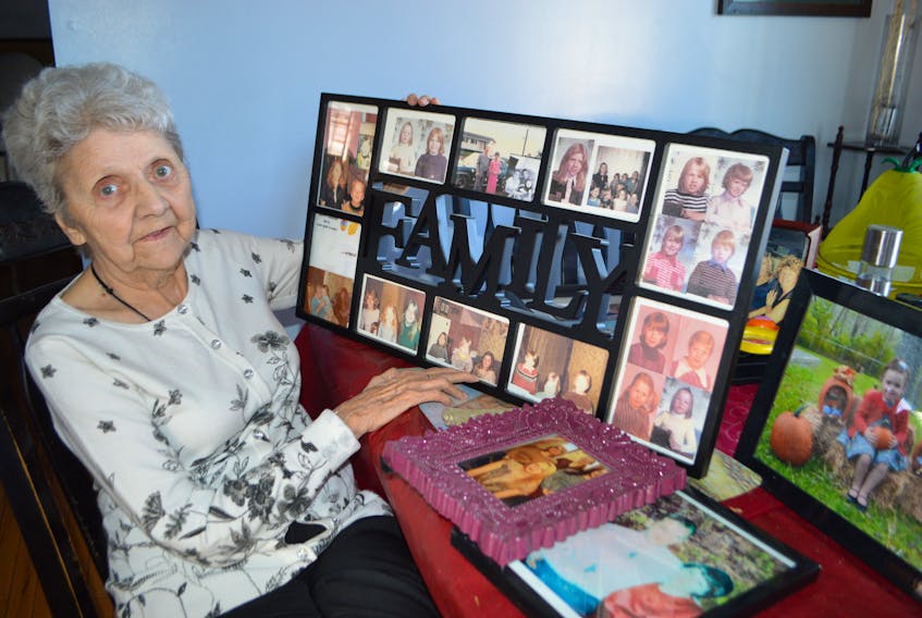 Mary McGillivary, 82, of Glace Bay, lovingly holds photos of many of her 20 children as well as grandchildren and great grandchildren. McGillivary said she's looking forward to Mother's Day as all her children will drop by. She said the one thing about an large family is that she's spoiled in a big way and loves it.
