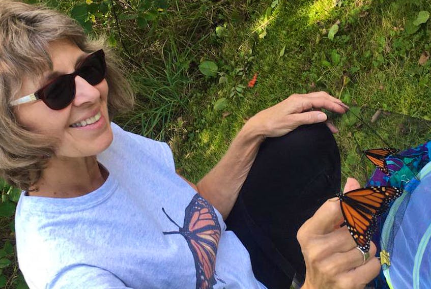 Lisa Proulx releases Monarch butterflies at the Isaiah W. Wilson Memorial Library in Digby this fall.