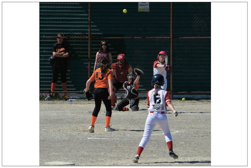 Softball players participating in the 2018 Const. William Moss Memorial Softball Tournament had to contend with warm conditions throughout Wednesday, the third day of play in the event being held at fields across St. John’s. Here, teams from Bay Roberts and the Southern Shore are shown in action in the girls under-14 division at Bannerman Park. Bay Roberts defeated the Southern Shore 2 entry 5-2. Play continues today in five divisions, including the boys under-16 event at Lions Park, where the championship final is set for 1 p.m.