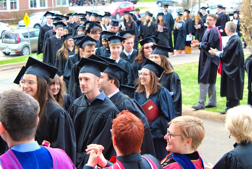 Graduates from Mount Allison’s Class of 2019 are all smiles as they receive applause from their professors as they enter Convocation Hall on Monday afternoon for their graduation ceremonies.