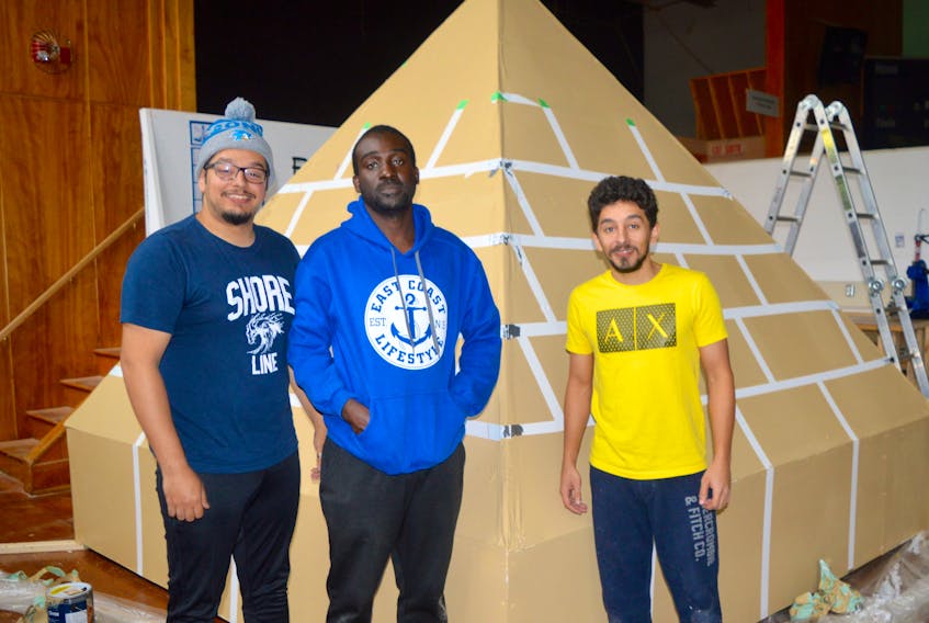 Hello Cape Breton: A World Gathering on an Island multicultural festival volunteers Ammar Tayeb, Deeno Tuger and Nofal Tayeb take a short break from their event preparations to pose in front of a scaled-down replica of an Egyptian pyramid. The trio is part of the team getting ready for Sunday’s festival that runs from 12-9 p.m. at the Joan Harriss Cruise Pavilion on the Sydney waterfront. The event is aimed at bridging and embracing the cultural differences of local Cape Bretoners and the many international newcomers that now live in the area.