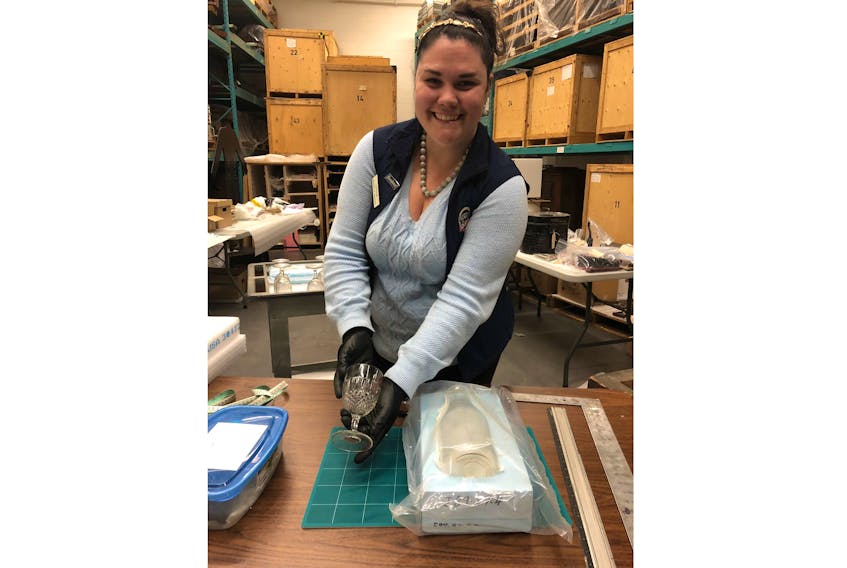 Erika Smith, curator of collections at the Museum of Industry, shows how items such as this Nova Scotia glass piece are carefully preserved and stored when not on display.