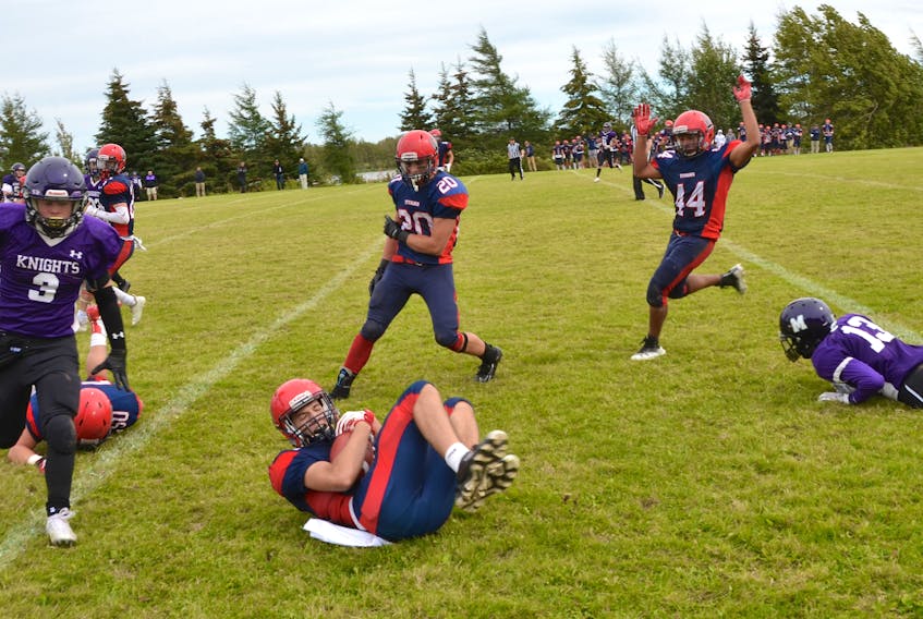 Tantramar Titan Ethan Doherty secures the ball as he dives for extra yards after running the ball back on an interception against the Moncton Purple Knights in a home game earlier this season. Doherty, who played for Team NB 2019, was recently named a U16 Football Canada Eastern Challenge All-Star.