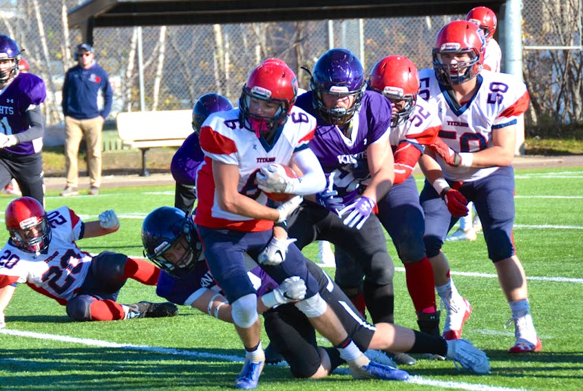 Titan Trevor Dulenty runs the ball in Saturday’s game against the Moncton Purple Knights.