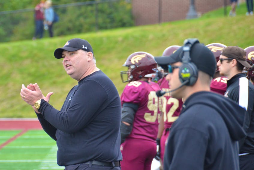 Mountie head football coach Peter Fraser, left, led his team to the playoffs for the first time in three years.