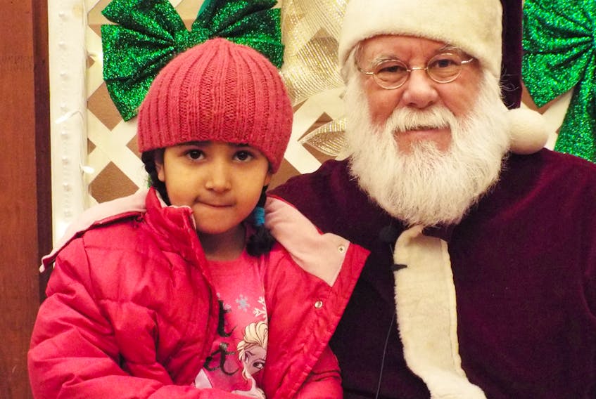 Rahmat Farag visits with Santa at the P.E.I. Association for Newcomers to Canada’s Christmas open house in 2015. All are invited to take in this year’s event 4-6 p.m. Dec. 12 at the Confederation Centre’s Memorial Hall. SUBMITTED PHOTO
