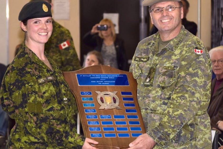 Officer Cadet Devon Greene, left, was awarded the First Battalion The Nova Scotia Highlanders Commanding Officers Shield during a recent ceremony as top student for basic military qualification. Presenting the plaque is Major George MacNeil, Deputy Commanding Officer, The Nova Scotia Highlanders.