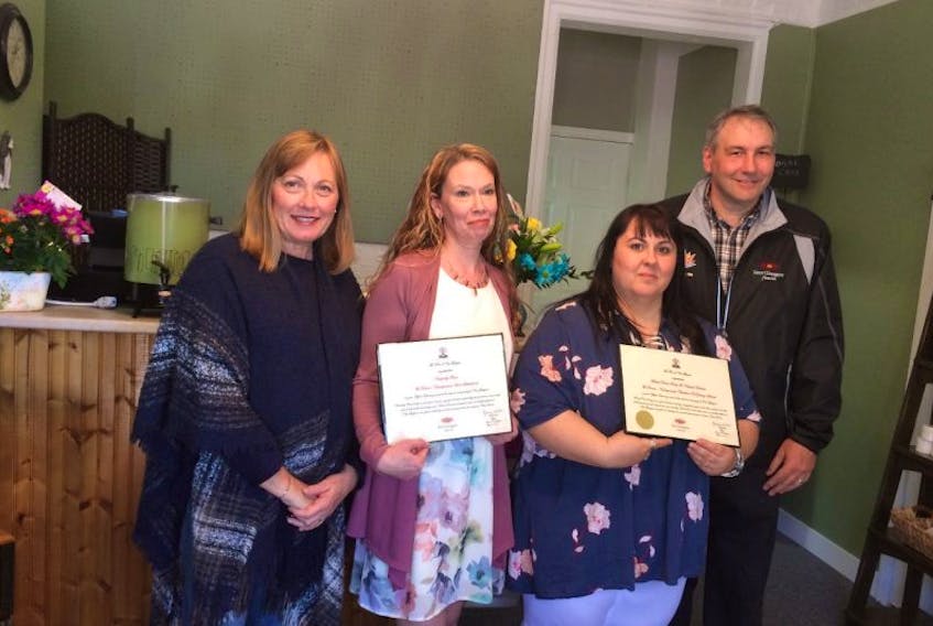 New Glasgow Mayor Nancy Dicks, left,  and New Glasgow Coun. John Guthro recently presented Lori Sutherland, second from left, owner of Naturally Bare, and Charlene DeYoung –Steeves, owner of Black Pearl Reiki, with welcoming certificates on the openings of their businesses in downtown New Glasgow.  The two women will run their own businesses out of one location on Provost Street. 