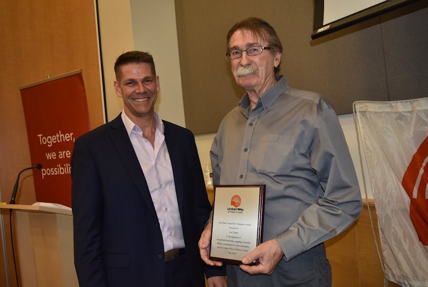 Outgoing Pictou County United Way president Aaron Millen, left, presents the Jack Pink United Way Volunteer Award to 2019 recipient Len Thomas.