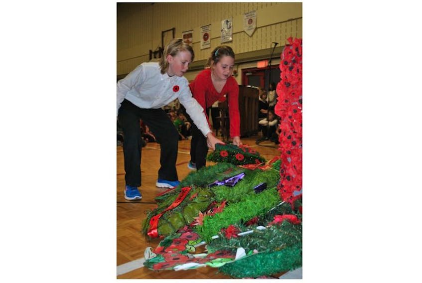 Aiden and Kiera Sims lay a wreath during the A.G. Baillie Memorial School Remembrance Day ceremony on Thursday.