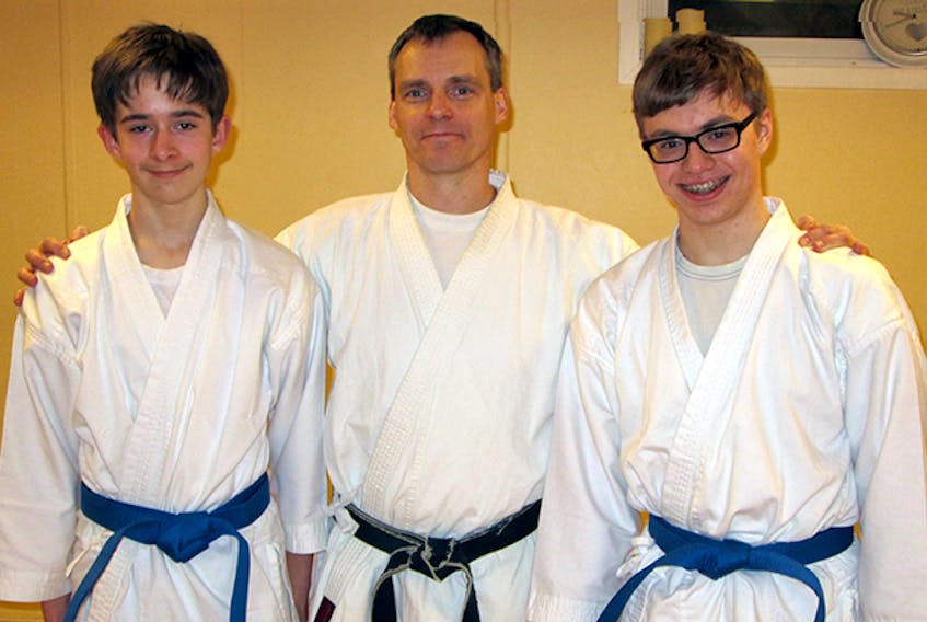 Chris Cruickshank, sensei and head instructor with the Northumberland Karate Club, is shown with Elias MacMillan, at left, and Kieran Bent after both received their Juvenile Blue Belts.
