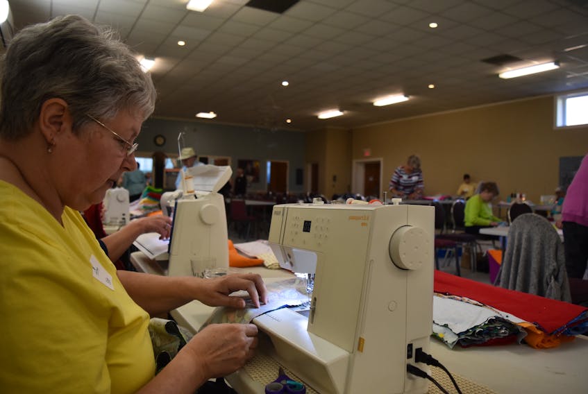 Edie Kennedy working on the sewing line as 54 more volunteers sew, stitch and cut yards upon yards of fabric for Ryan's Case for Smiles. This year the volunteer organization aimed to make over 700 pillows for children coping with life changing illness and injuries.
