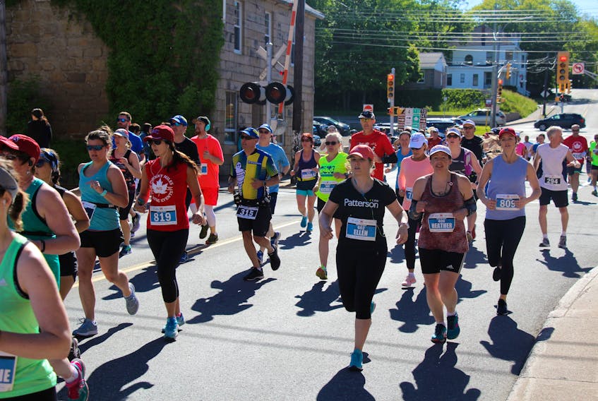 Runners head up George Street in New Glasgow during the 2018 Johnny Miles Marathon.