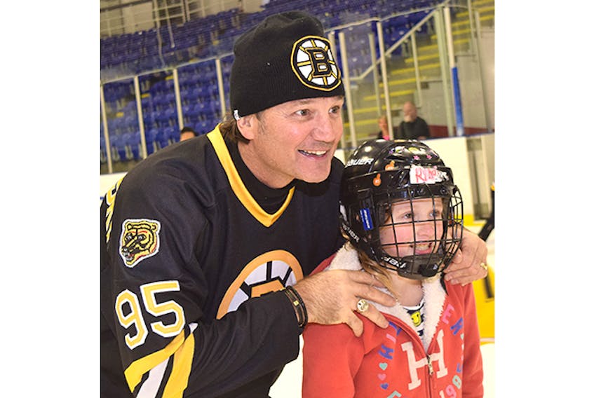 Former members of the Montreal Canadiens and Boston Bruins held an afternoon public skate, in advance of an alumni game Wednesday night between the two NHL rivals. Ex-Boston Bruins winger Mike Krushelnyski, who won three Stanley Cup with the Edmonton Oilers, poses for a photo with Rihana MacKay of Plymouth.