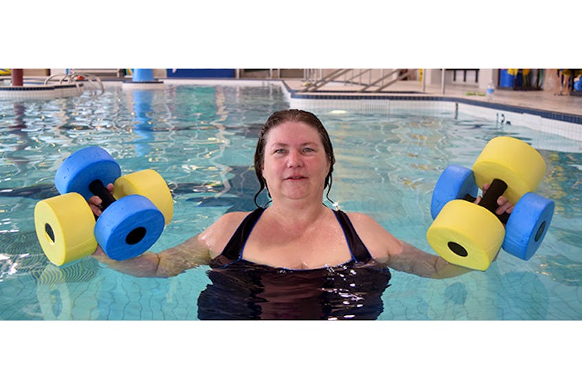 Brenda Scully, an aquafit instructor with the YMCA, is shown with some water weights at the YMCA pool.