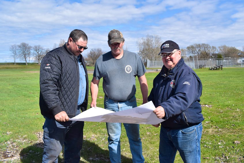 Westville Fire Department members Bill Chace, left, Kenny Dunn and Tom Steele look over some blueprints for the major renovations at Victoria Park. The three-phase project is expected to take two years to complete.