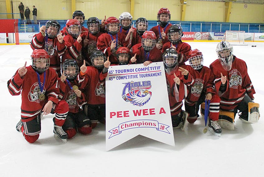 Shown with their tournament championship banner are the Pictou County Peewee A Crushers (red). In front row are: Evan Tucker, Lucus MacDonald, Corbin MacDonnell, Cameron Munroe, Brady Croft, Cole Miller, Alex Palmer, Amias Crossman and Ethan MacLaren. In back are: Carson Moore, Leland Tobin, Jack Higdon, Caden MacDonald, Owen Chabassol, Marshall Brown, Scott Mosher and Thatcher Keay.