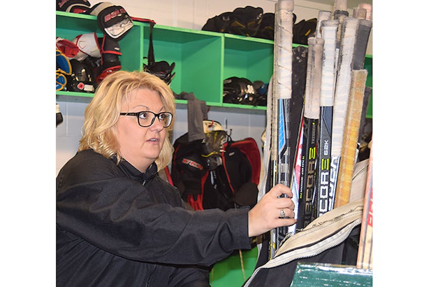 Pictou County Scotians team manager Stacey Murphy packs some sticks as the junior hockey club prepared to bus to Cumberland County on Friday for a Nova Scotia Junior Hockey League game.