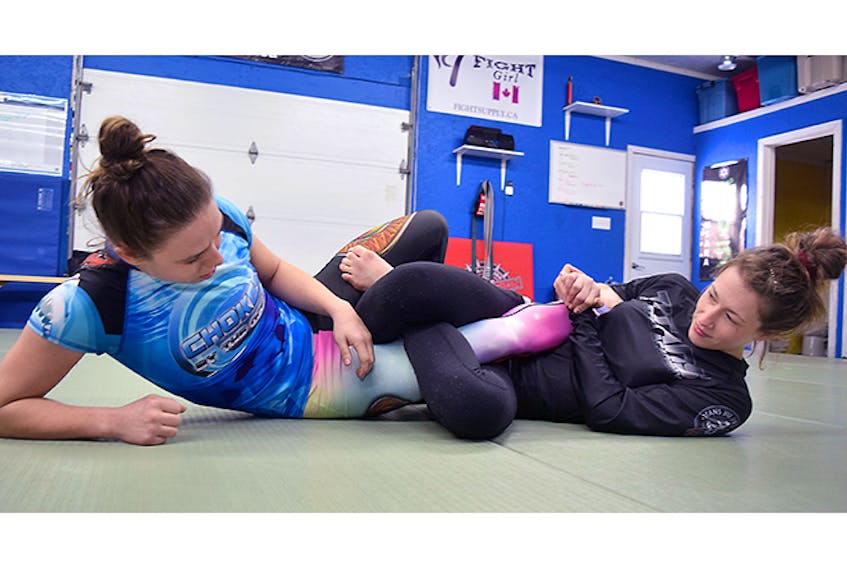 Hayley MacLeod, at right, demonstrates a heel hook manoeuvre on Kelly Horvath.