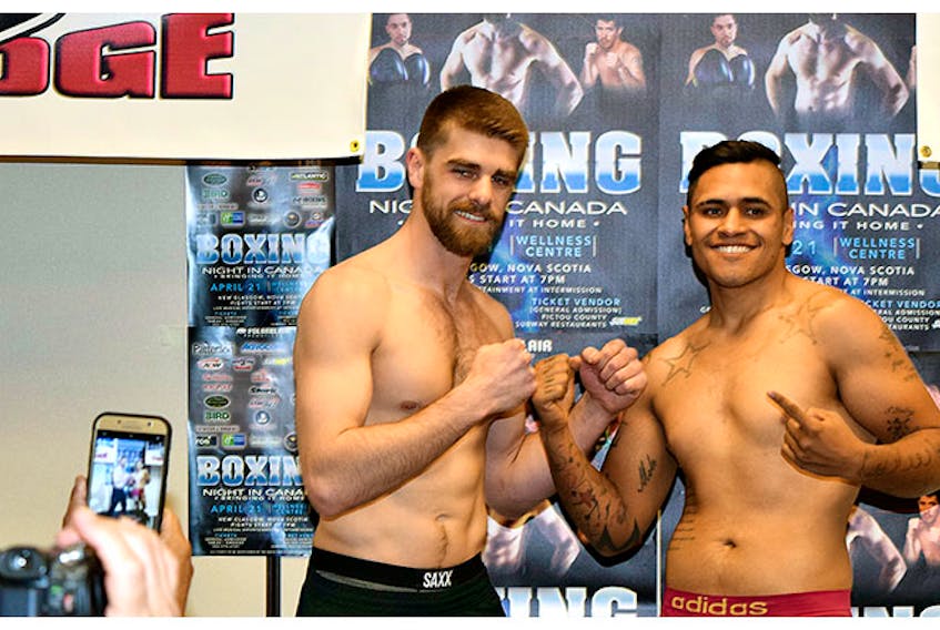 Pictou County’s Brody Blair and his opponent Juan Raygosa pose at their weigh-in on Friday, which was held at the Holiday Inn Express, leading up to their fight on Saturday at the Pictou County Wellness Centre.