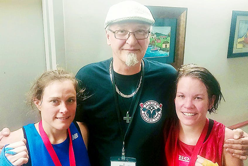 Albion Amateur Boxing Club president Jim Worthen is shown with Shauna Fukes (right) and her opponent Joanne Moxsom.