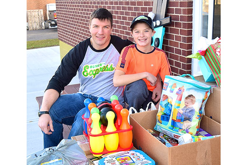Drew Graham and his son Jax with some of the toys that will go to children at the IWK in Halifax.