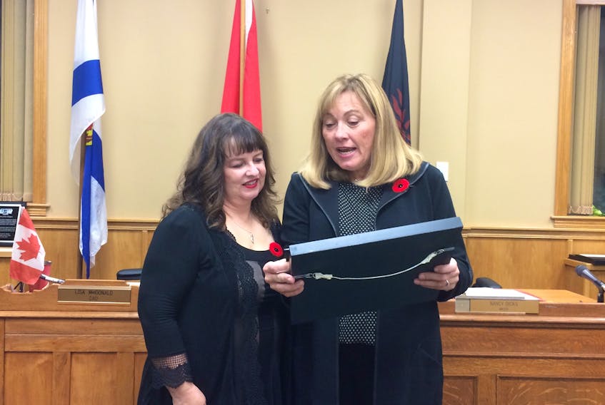 New Glasgow Mayor Nancy Dicks presents Kimberly Dickson with a plaque commemorating her service as director of marketing and communications.