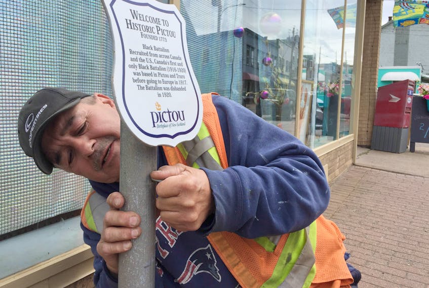 Sean Knowles of the Town of Pictou’s public works department installs new placards in the town so visitors and residents can learn some history about the town as they stroll through the streets. The placards have been there in the past but were recently replaced with new ones.