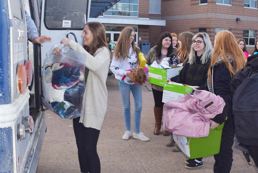 North Nova Education Centre students load a bus with toys and food that will be given to families in need this holiday season.