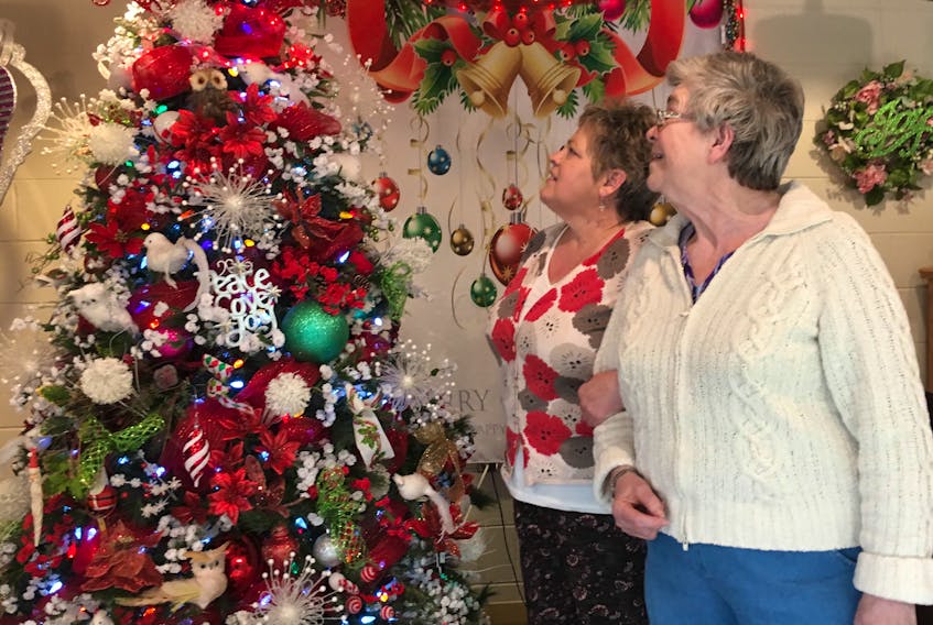 Cindy MacLean, left, enjoys decorating Valley View Villa every year for Christmas much to the delight of residents and staff. She is pictured showing one of the residents some of the decorations.