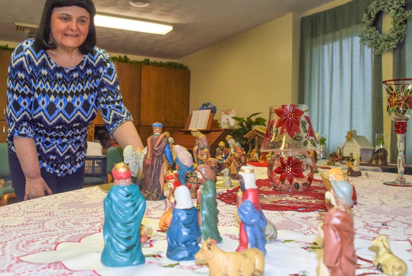 Heather Spears with Church of Jesus Christ of Latter-day Saints in New Glasgow tends to one of the many nativity scenes on display at the church.