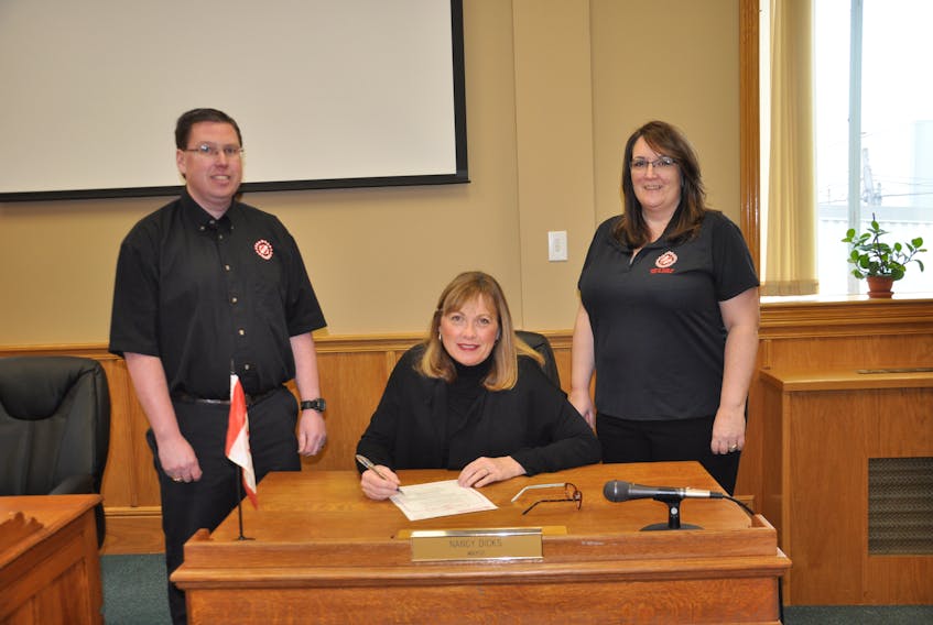 New Glasgow mayor Nancy Dicks signs a proclamation declaring Feb. 18-24 Kinsmen and Kinettes Week on Feb. 20, flanked by Brian McIntosh and Mary Macleod, representatives with the New Glasgow Kinsmen and Kinette clubs.
