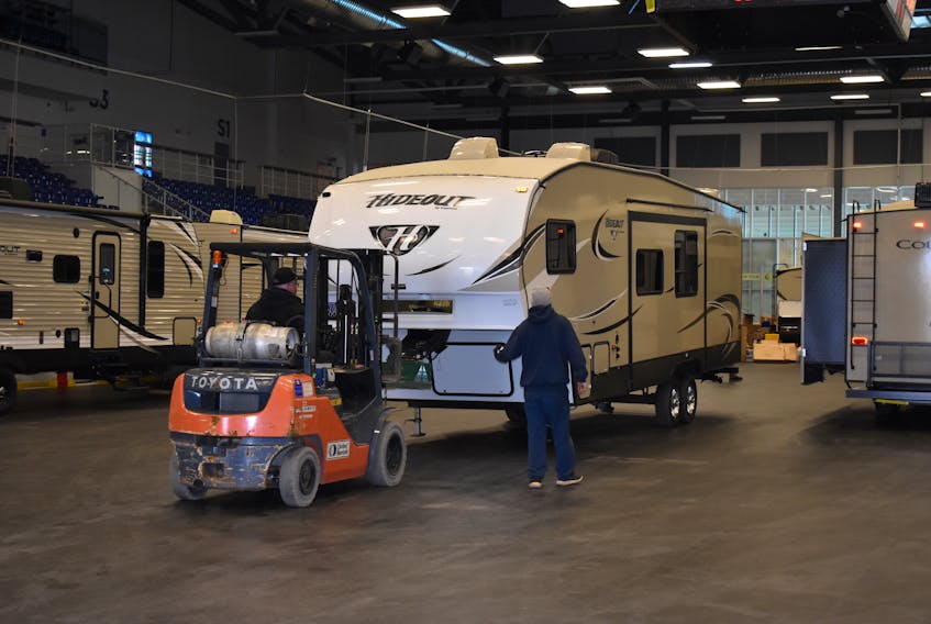 One of many RVs that will be on display this weekend at the Bell Aliant Arena is carted indoors on Wednesday afternoon.