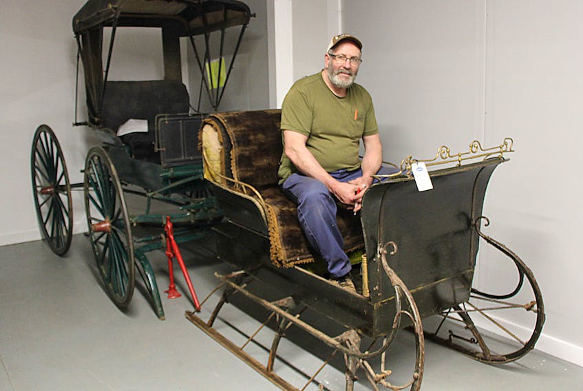 Alan Fraser, owner of A Walk Through Time Museum, in Scotsburn sits in a MacLaughlin sleigh he purchased from Murray and Carol Innis in Pictou.   The sleigh sits in front of a MacLauglin carriage and both were built before cars started to be manufactured in the early 1900s.    Fraser’s museum will have its official grand opening Sunday from 10 a.m. to 5 p.m. at 4119 Scotsburn Road which is upstairs in the former Scotsburn Dairy Creamery building.