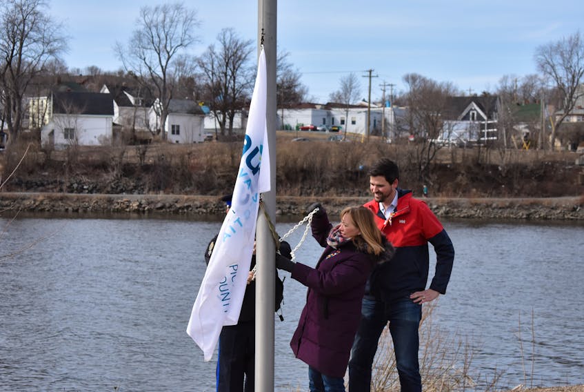New Glasgow Mayor Nancy Dicks and Central Nova MP Sean Fraser raise the official flag marking Autism Awareness Day on April 2. The flag raising was the precursor to the official opening of the local Autism Resource Centre at Glasgow Square. – SYMONNE OUTHOUSE
