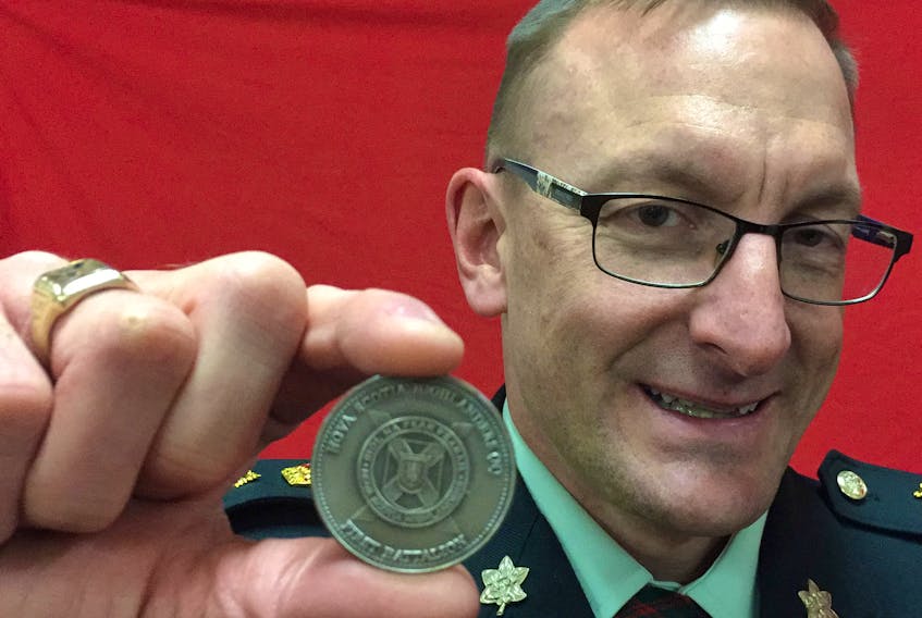 Lt.-Col. Colin Todd holds a a Nova Scotia Highlanders ceremonial unit coin that was presented to the Stellarton Legion.