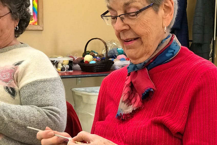 Sophia Pickles, working on one of her most recent knitting projects at the weekly knitting circle at the New Glasgow library.