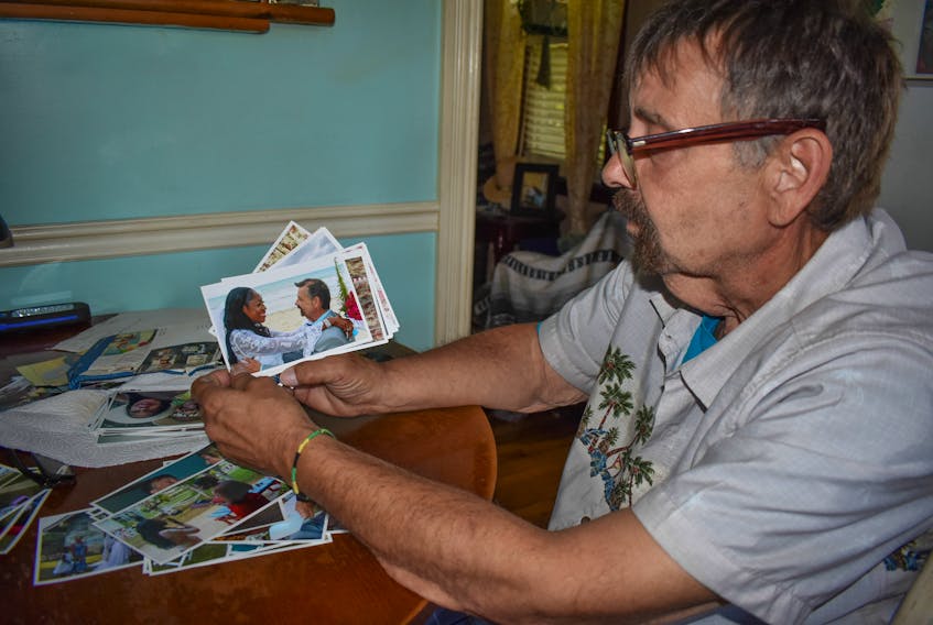 Bill MacArthur sits in his Rose Avenue home in Trenton and shows a picture of his wife in Jamaica. They’ve been trying since 2016 to get her a permanent residency visa to be able to move to Canada but have been denied.