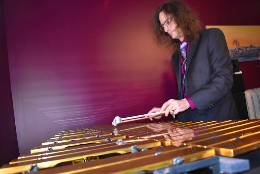 James Stuebing plays a vibraphone in his home in New Glasgow. He is offering an affordable recording service for people in Pictou County and also plans to start a guitar painting business.