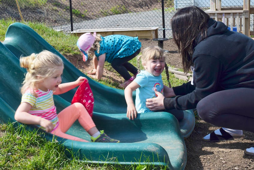 Emily Mattatall helps children at the Spring Garden Child Care Centre as they use the slide at the care centre. Mattatall was part of a Northumberland Regional High School class that has been periodically visiting Spring Garden Child Care Centre over the past few weeks as part of their Child Studies class.