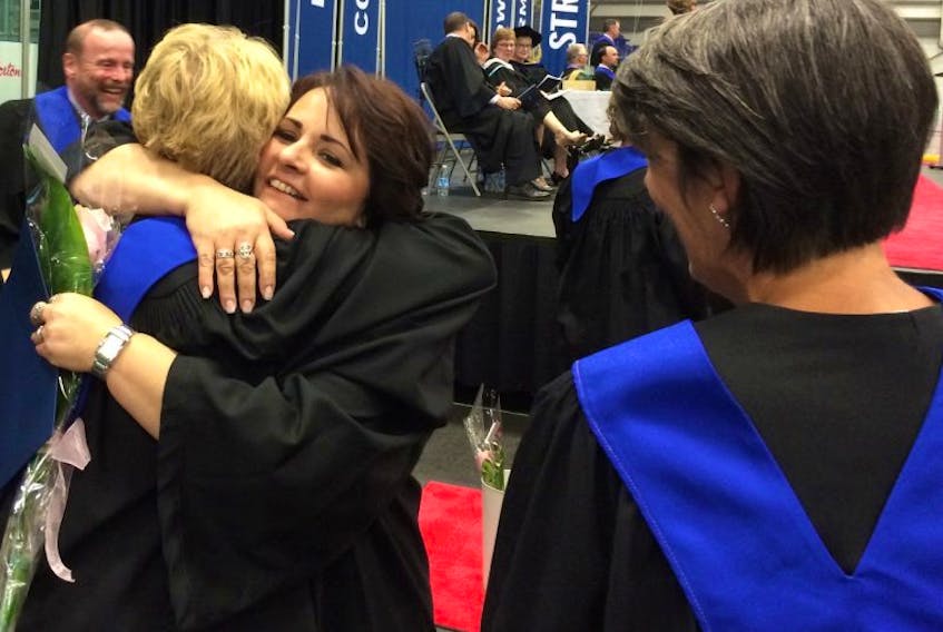 Carole MacKinnon receives a hug from a faculty member at the Nova Scotia Community College Pictou campus convocation on Thursday.