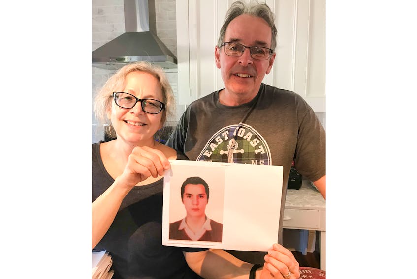 Stephen MacKenzie and his wife Donna Collins of Pictou hold a picture of Bader Albarazi who will be coming to the area from Turkey at the end of the month.