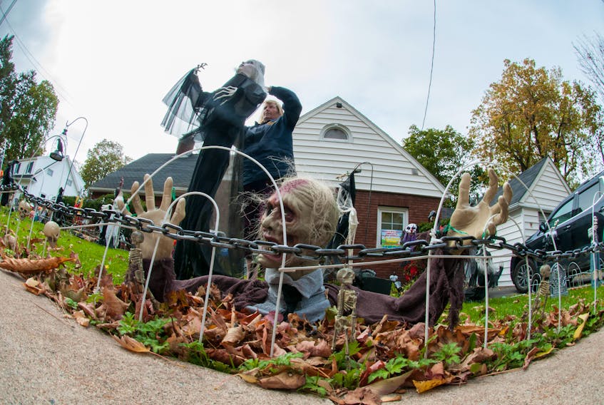 Donna MacIntyre repairs her ghoulish display that was knocked down by recent winds on High Street in New Glasgow. Her display is a highlight in the area. People make a point of driving down her street to see what she has up each year. MacIntyre says she changes themes each year and adds new decorations for each. This year’s is clown and skeletons.